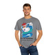 Grey Comfort Colors t-shirt with a cartoon chicken surfing and shouting “Cluck Yeah!” with the words “Poultry-Powered, Coffee-Fueled.” Male Model