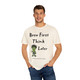 cream tee with frazzled green gecko (Bert) holding coffee cup and text “Brew First Think Later” – funny coffee shirt by Coo Coo’s Coffee