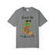 Grey short-sleeve tee showing Bert the gecko riding a surfboard with sunglasses and orange shorts, “Surfs Up – Jax Beach, FL” text, Bert’s Surf Club – Jax Beach Tee by Coo Coo’s Coffee.