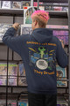 Back view of navy Geckos Don’t Sleep, They Drum hoodie by Coo Coo’s Coffee — gecko drummer design with bold drum kit graphic, perfect for coffee lovers and music fans at the record shop