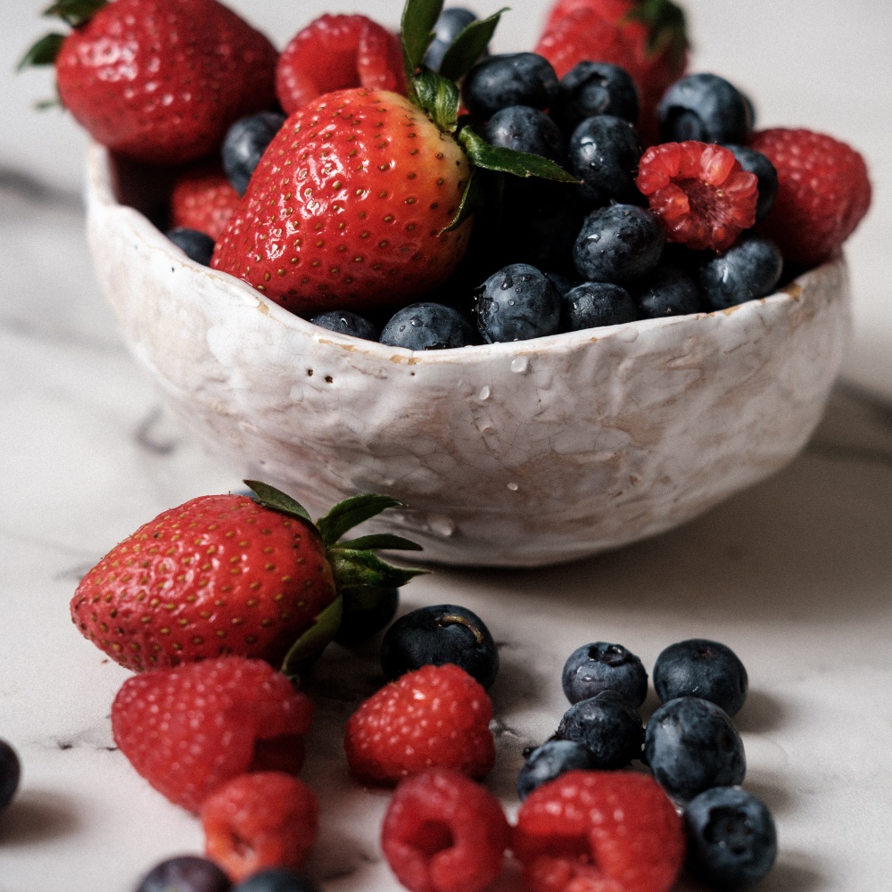 Bowl of mixed berries with berries on the counter