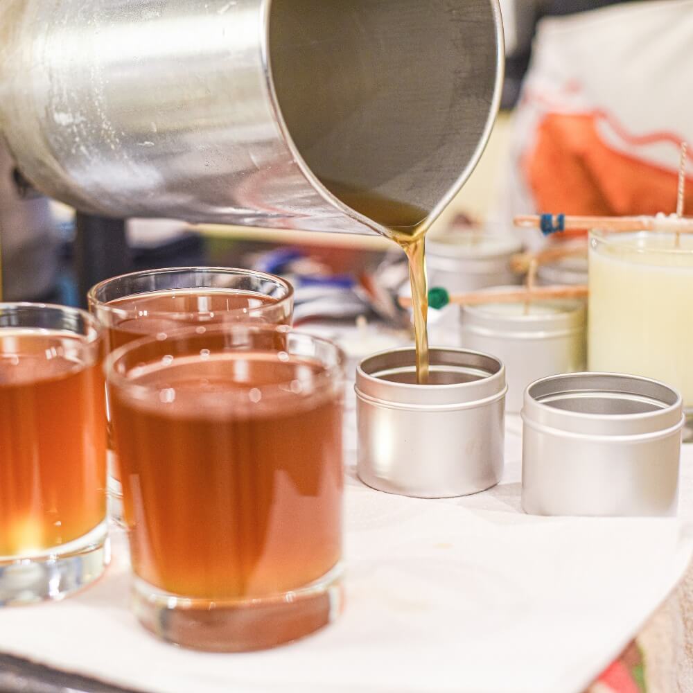 Pouring wax into jars for small-batch seasonal candles