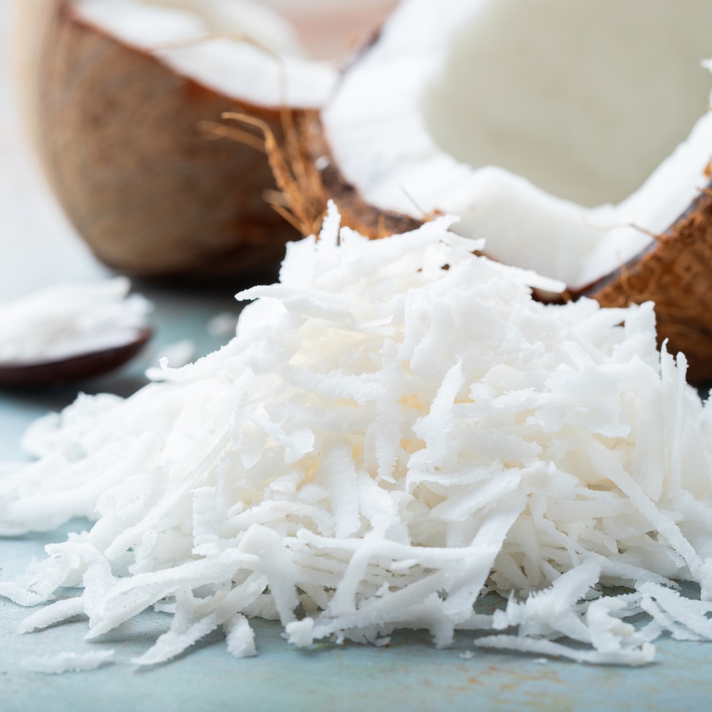 Coconut shells with shredded coconut on a counter