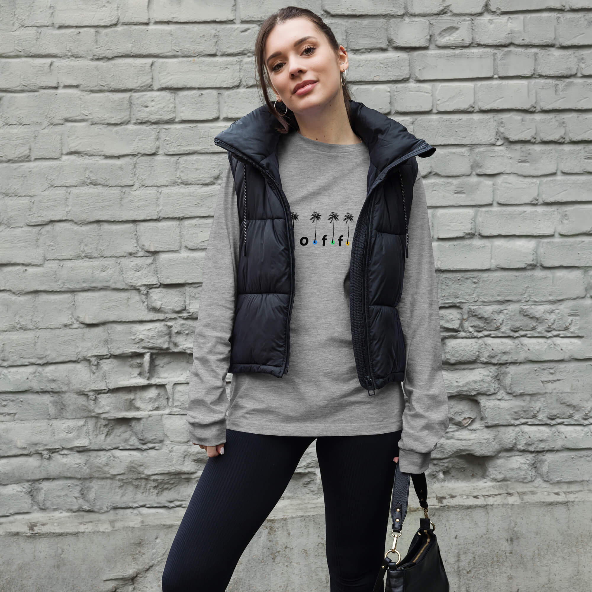 Light grey Coffee with Colored Dots and Palm Trees long sleeve tee shirt. Female model with hand bag.