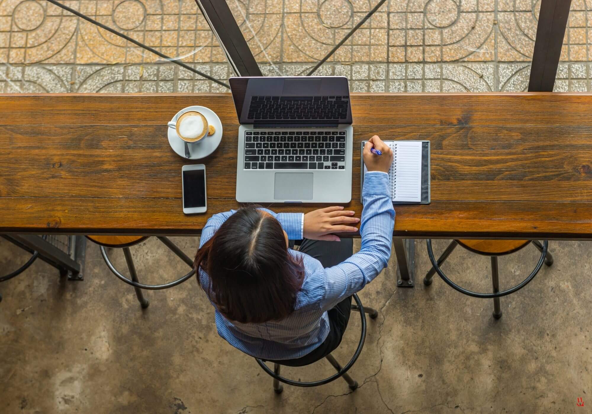 Person reading coffee cards at a cafe bar