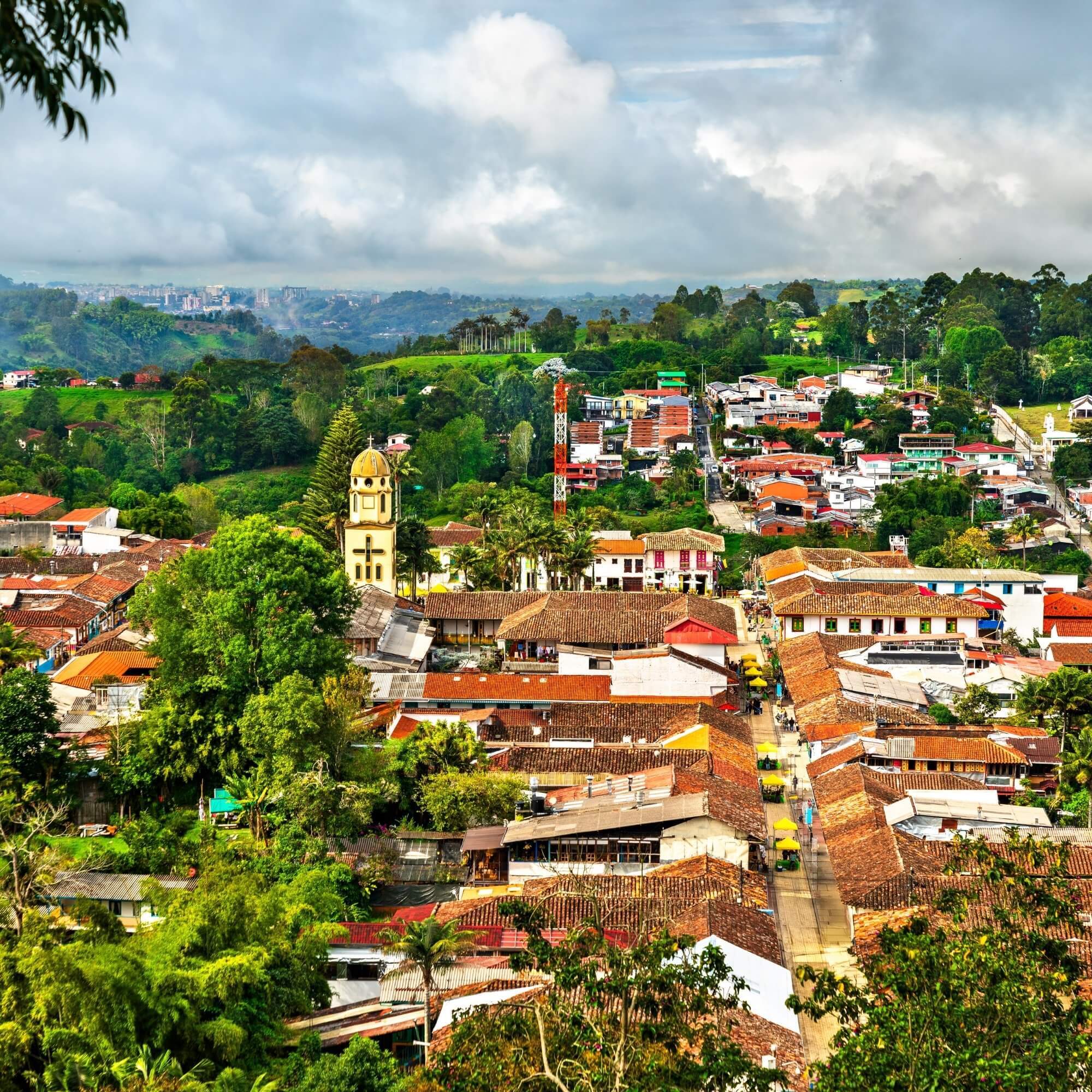 Colorful Colombian town street with mountains behind