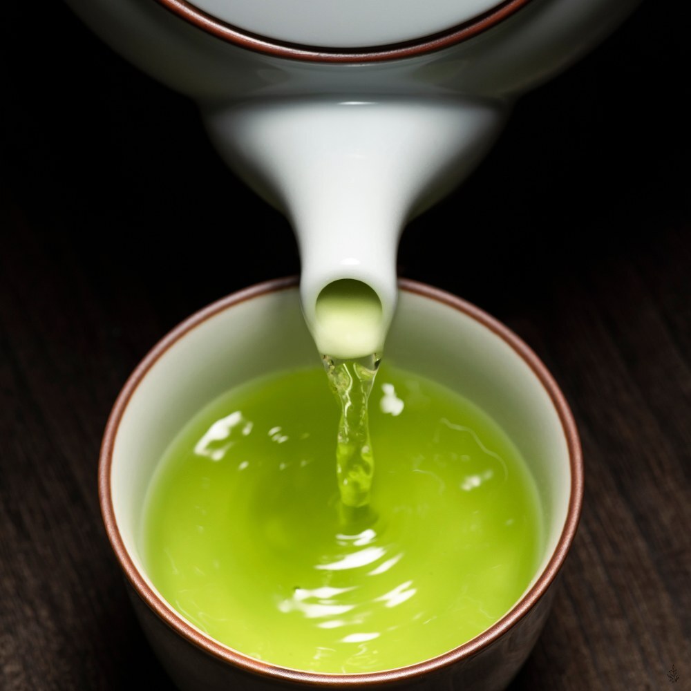 Green tea leaves and a fresh brewed cup (placeholder image)