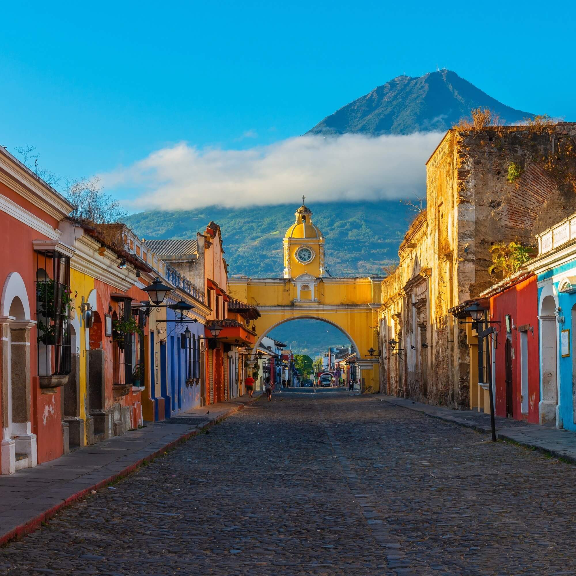 Colonial street in Antigua, Guatemala with volcano in background