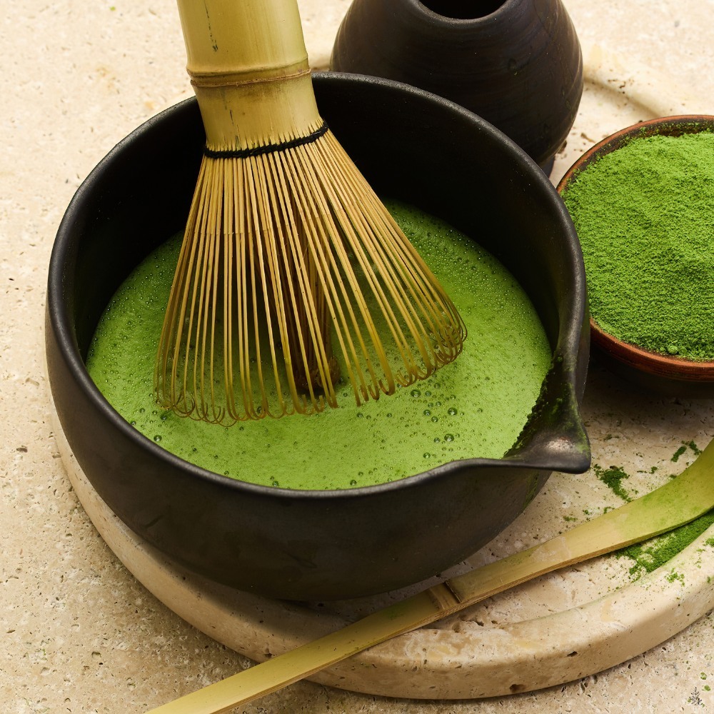 Matcha powder and a whisked matcha bowl (placeholder image)