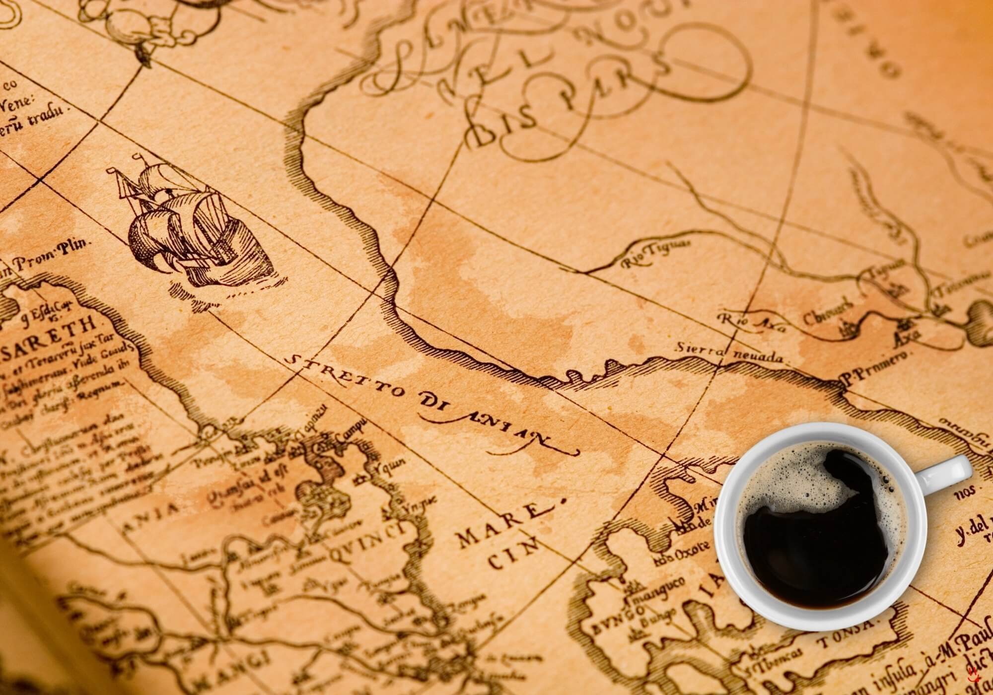 Cup of coffee over vintage shipping map