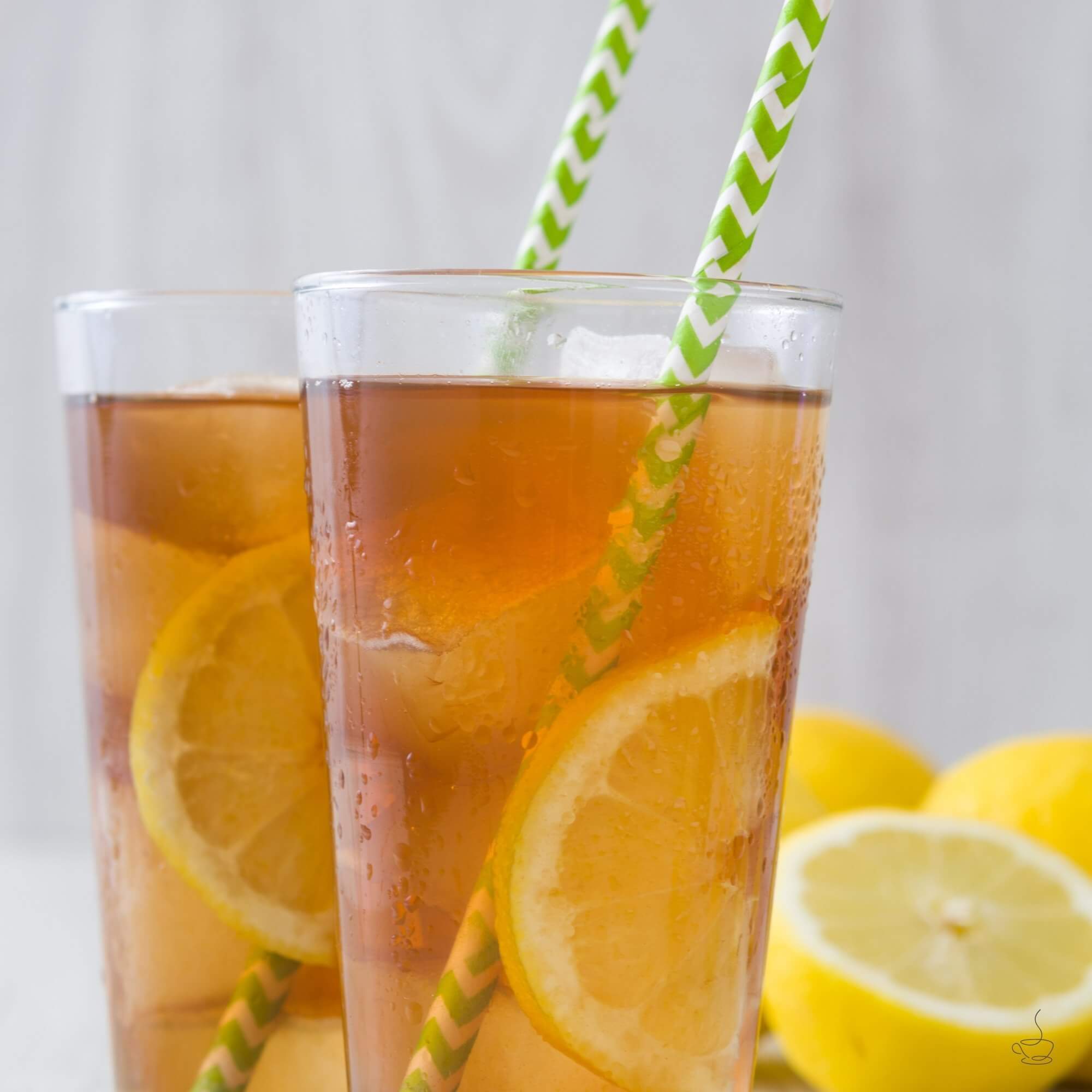 Pitcher and glass of house iced tea with lemon slices