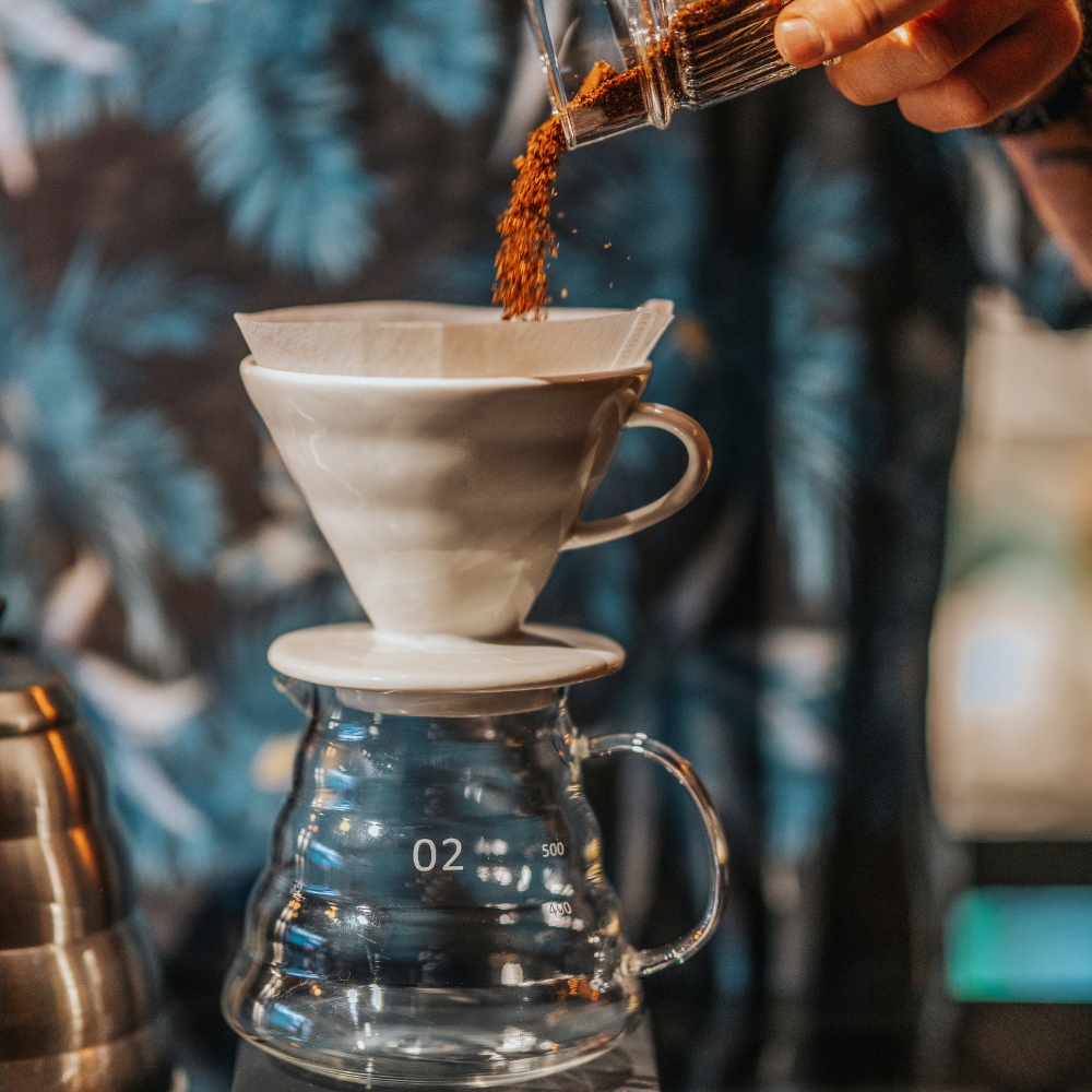 Operator charging the coffee roaster