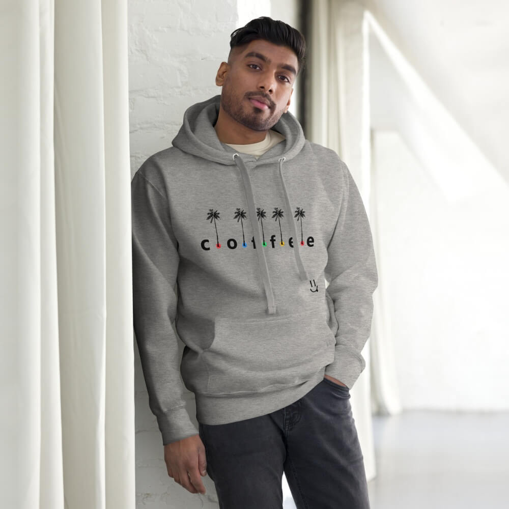 Coffee with Colored Dots and Palm Trees light grey hoodie. Male model leaning against wall.