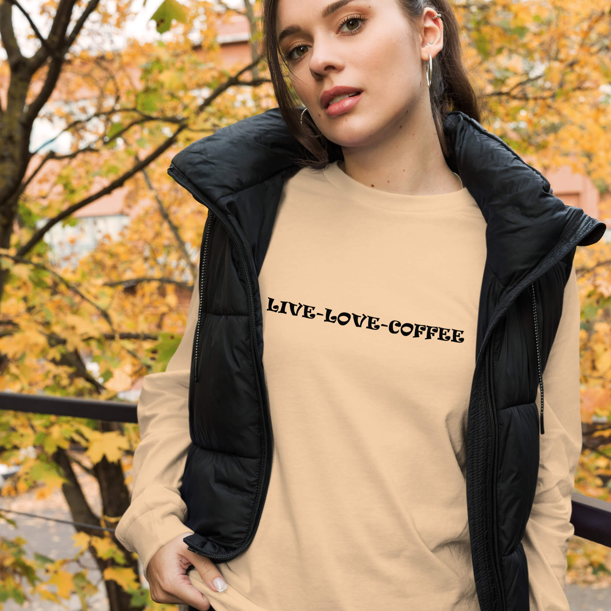 Live-Love-Coffee long sleeve tee shirt, sand dune color. Female model with trees in background.