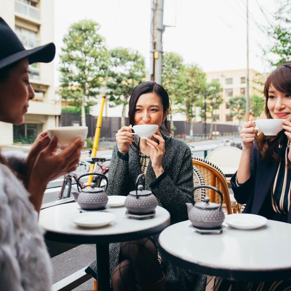 Group of women drinking tea outdoors