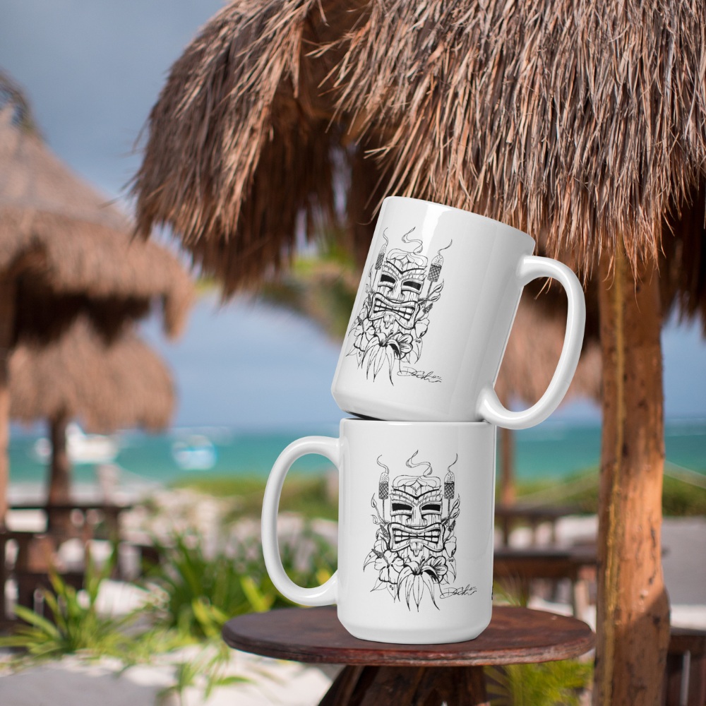 Stack of tiki man by Dan coffee mugs on a table at a beach tiki bar.