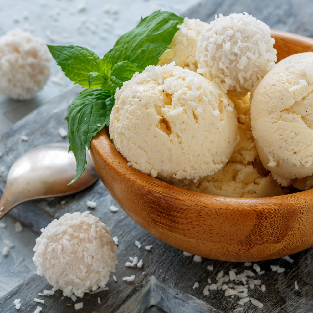 Wooden bowl of vanilla ice cream with coconut