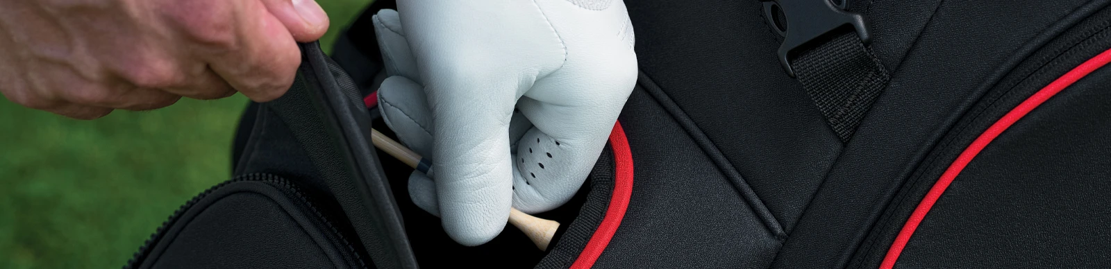 golfer getting a tee out of a pocket on his golf bag - for Golf Bag Tips: 10 Common Mistakes Made in Packing and Carrying a Golf Bag content section