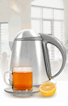 Glass of tea and lemon placed in front of electric tea kettle.