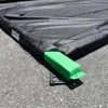 Foam wall containment berm corner with green support in place for spill containment and stability.