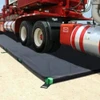 Heavy-duty truck on a foam wall containment berm designed for chemical spill control and industrial safety.