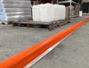 Berm Builder Plus in an industrial environment with pallets and containers.