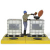 Worker adjusting valves on water storage tank in industrial environment.