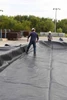 Team adjusting the black liner to fit within the containment area.