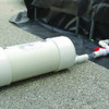 Close-up of a self bailer draining liquid efficiently from a container in an industrial setup.