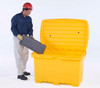A man wearing a red hard hat and gloves placing a toolbox into a yellow utility box with an open lid, highlighting its storage capability.