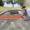 Spill Berm Plus deployed on uneven terrain, effectively adapting to the surface to create a secure barrier.