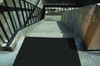 Black tactile ADA pad installed at the top of a stairway, ensuring safety and accessibility. Black tactile ADA pad installed at the top of a stairway, ensuring safety and accessibility.