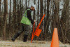A construction worker using the stake driver to drive stakes into an erosion control mat