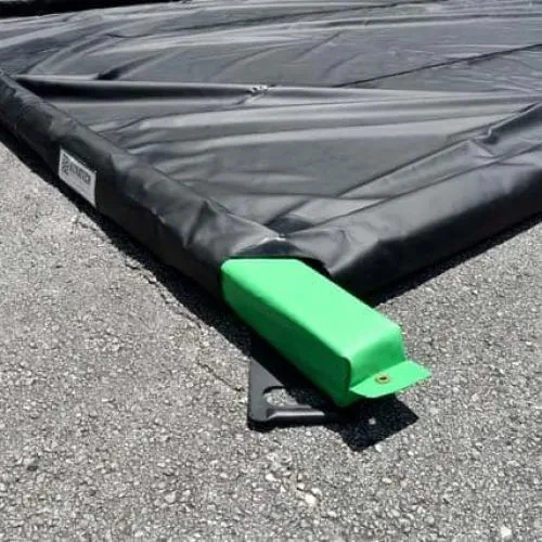 Foam wall containment berm corner with green support in place for spill containment and stability.