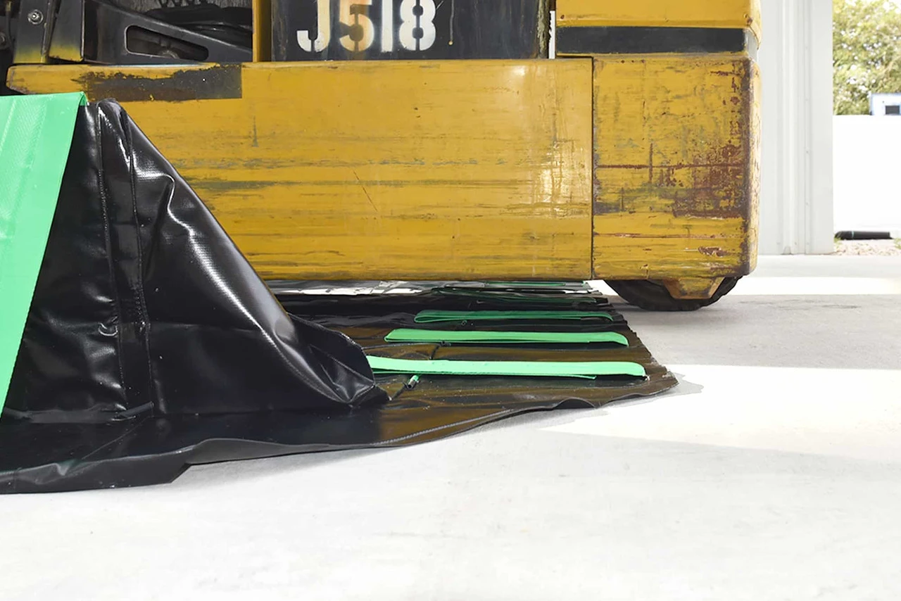 Close-up under forklift - Containment berm in use with a forklift on a reinforced corner.