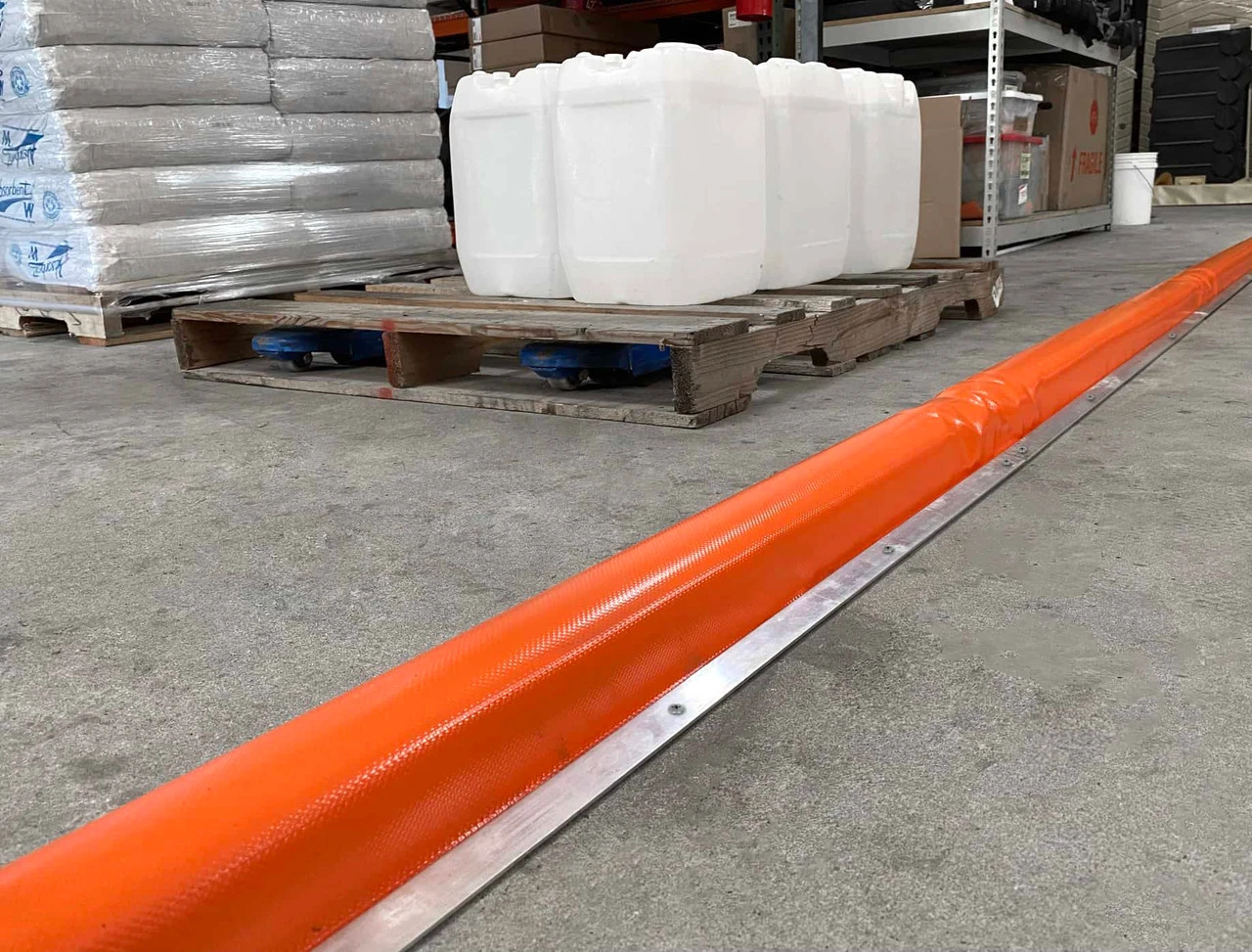 Berm Builder Plus in an industrial environment with pallets and containers.