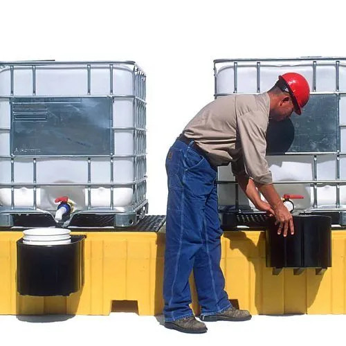Worker setting up containers on the Twin IBC Spill Pallet, No Drain, demonstrating its user-friendly design and industrial-grade performance.