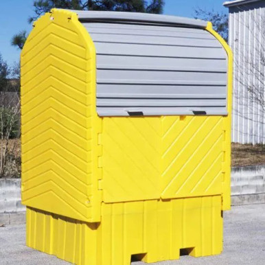 A closed, yellow, single IBC hard top storing and securing a IBC container from the outside weather by a job site.