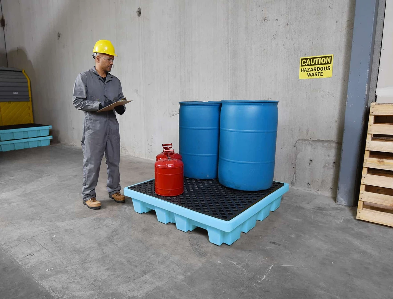 Fluorinated 4-drum spill pallet in a chemical storage area