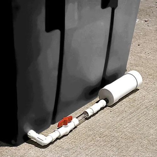 Self bailer installed on a black container for automatic liquid removal and debris retention.