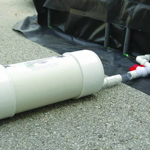 Close-up of a self bailer draining liquid efficiently from a container in an industrial setup.