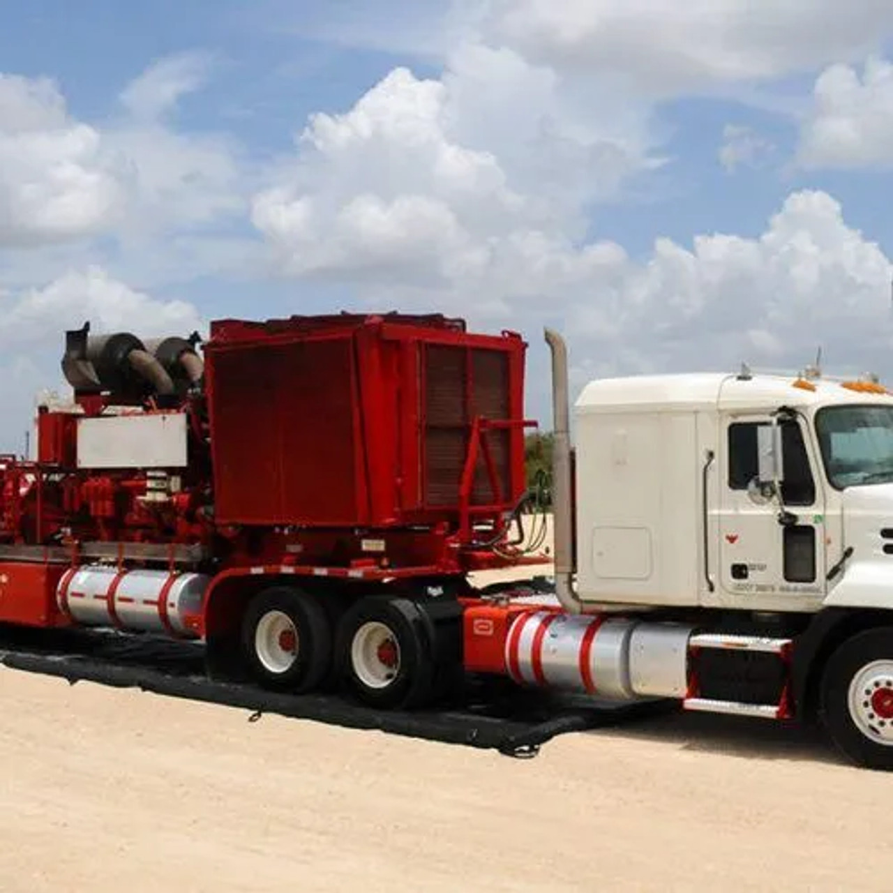 Mobile spill containment setup with truck and equipment in a field.