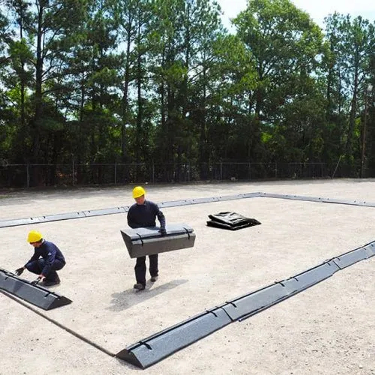 Workers carefully installing a waterproof liner on a flat surface, ensuring long-lasting protection.