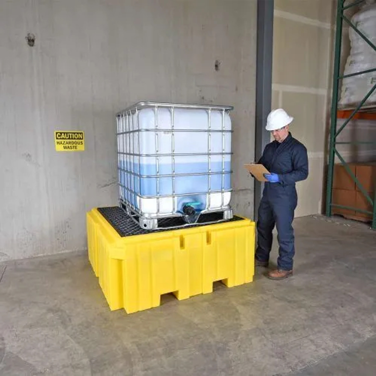 Worker inspecting an IBC Spill Pallet Plus, No Drain, designed for industrial-grade spill containment and secure hazardous material storage.
