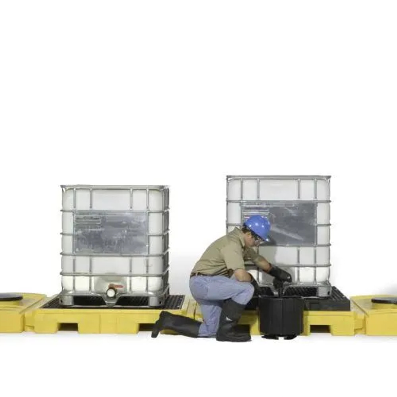 Close-up of large water tanks being checked by technician in factory.