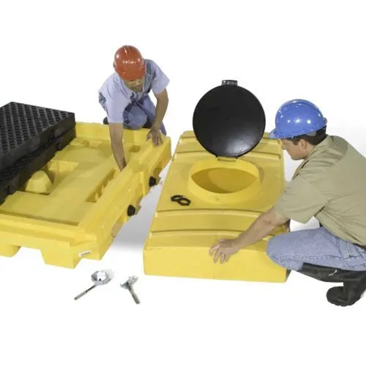 Workers handling water tank components with safety equipment in warehouse.
