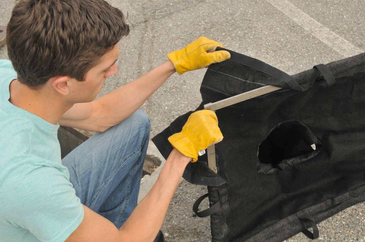 Worker replacing a adjustable filter guard for compliance on the jobsite and to insure proper filtration over a period of use.
