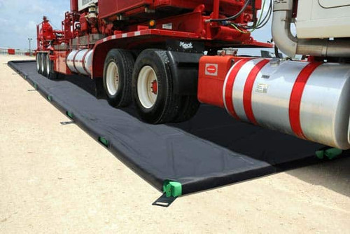 Close-up of a truck wheel on a foam wall containment mat for chemical spill prevention.