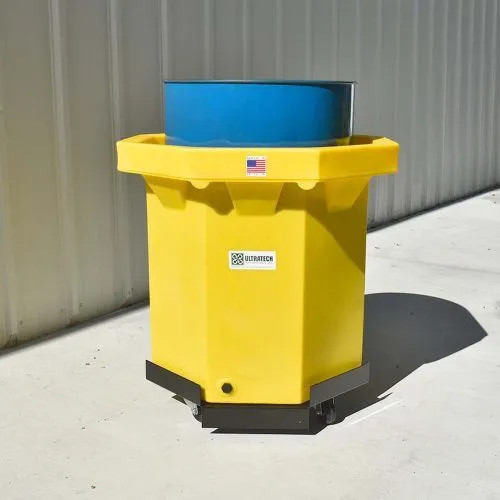 Flat Bottom Spill Collector placed outdoors, showcasing its sturdy and compact design for spill management.