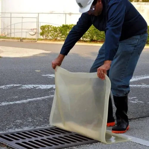 Clear drain seal being positioned over a storm drain, highlighting its 18” x 18” size and easy application for environmental protection.